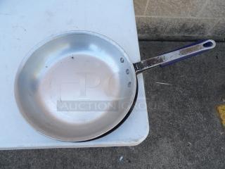 10" commercial frying pan, metal construction, visible wear on handle, suitable for heavy-duty cooking.