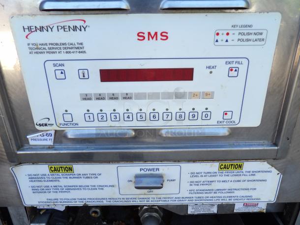 Henny Penny PFG-690 stainless steel pressure fryer with filtration, controls visible. 100,000 BTU, on commercial casters.