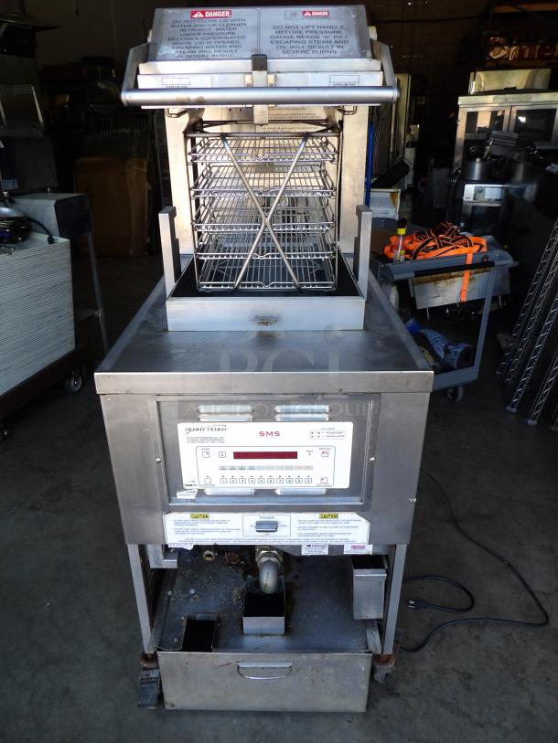 Henny Penny PFG-690 stainless steel pressure fryer with filtration, natural gas, 100,000 BTU, on casters, 25x41x63 inches.