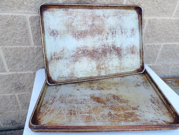 Full commercial size metal pans, set of 5, used condition, visible wear and scratches, ideal for high-capacity baking.