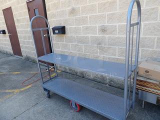 Regency 16" x 63" heavy-duty U-Boat utility cart with center brakes, metal frame, dual shelves, sturdy condition.