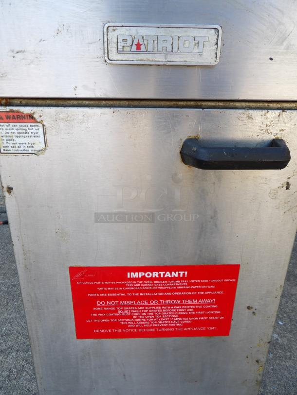 Patriot Model FM-90-NG natural gas deep fryer on casters, stainless steel, visible branding, warning labels, moderate wear.