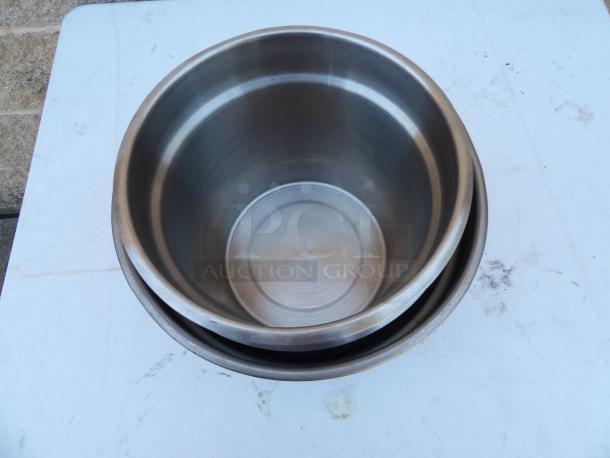 Stainless steel steam pots, 9-inch round, 8-inch deep, shown nested. Appears in good condition, showing clean interior.