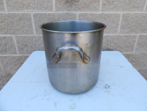 24 Qt. standard weight aluminum stock pot with handles, showing signs of use and patina, sturdy and functional.