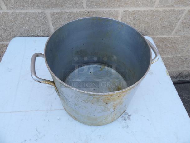 24 Qt. standard weight aluminum stock pot, used, noticeable wear; sturdy handles; ideal for large volume cooking.