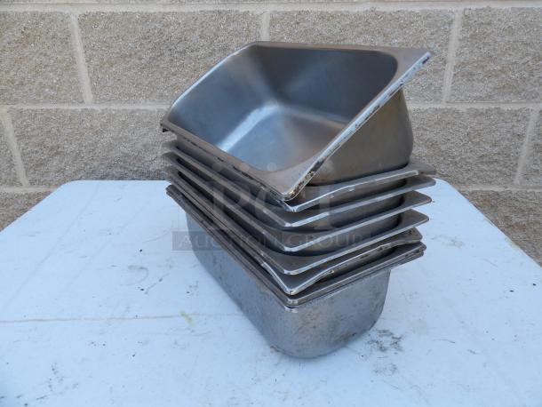 Stack of 1/3 size, 4" deep anti-jam stainless steel steam table pans, 24 gauge. Used condition with visible wear.