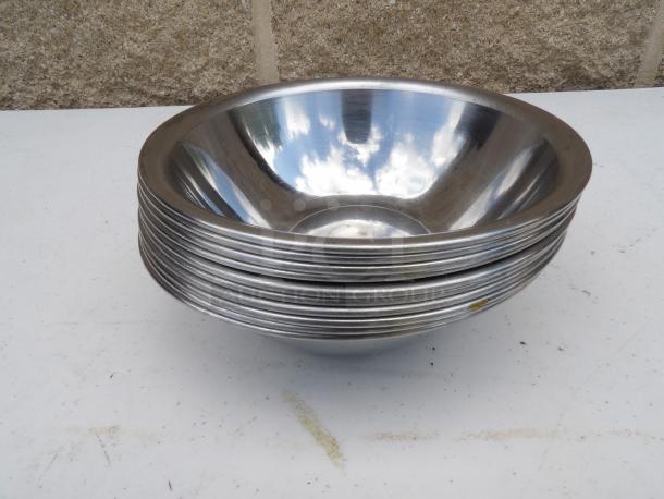 0.50 Qt. standard stainless steel mixing bowl, 6" round x 2" deep, slight wear, reflective surface, stackable design.