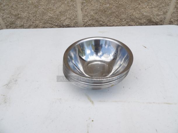 Stainless steel mixing bowl, 0.50 qt, 6" round x 2" deep, shiny finish, minor surface marks.