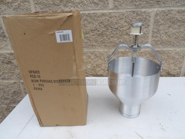Brand new 88 oz. aluminum pancake/waffle batter dispenser, model PCD-13, includes original box, visible label with specs.