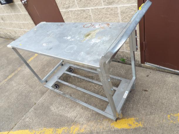 Two shelf chrome utility cart, 18"x52", heavy duty, minor wear. Sturdy metal frame with caster wheels for mobility.