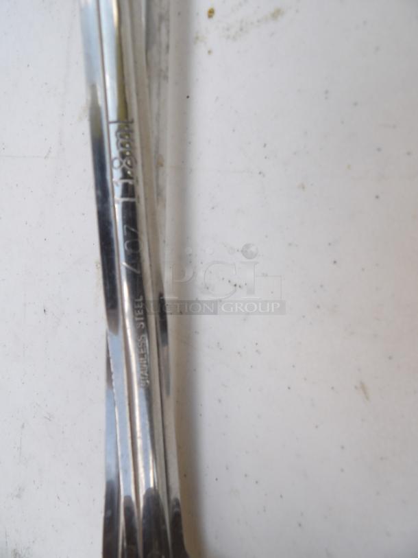 Two stainless steel 4-ounce ladles, marked "STAINLESS STEEL" on the handles, polished finish.