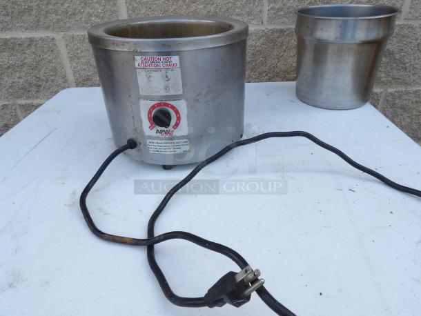 APW Wyott food warmer with power cord, adjustable temperature dial, and caution label; shows wear, powers on and heats.