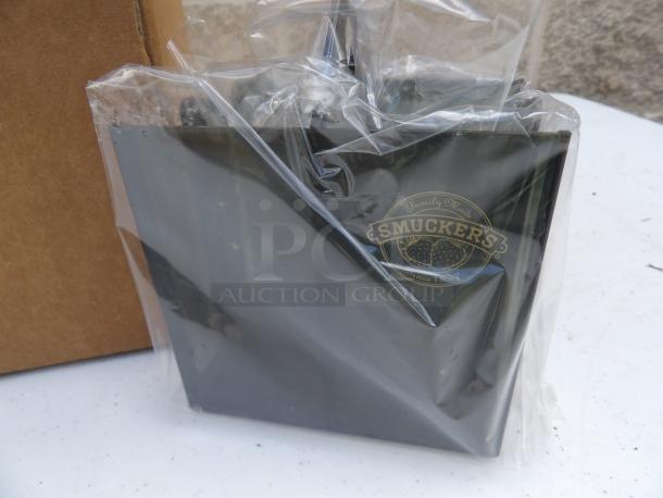 Brand new Smucker caddy with logo, sealed in plastic. Black color. Includes 11 identical items for same price.