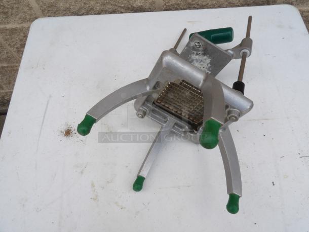 Garde Metal Countertop Vegetable Cutter with green handles, stainless steel blades, and signs of wear on metal surface.