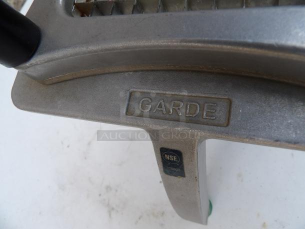 Garde Metal Countertop Vegetable Cutter, features sharp blades, durable metal build, "Garde" and "NSF" markings visible, sturdy design.