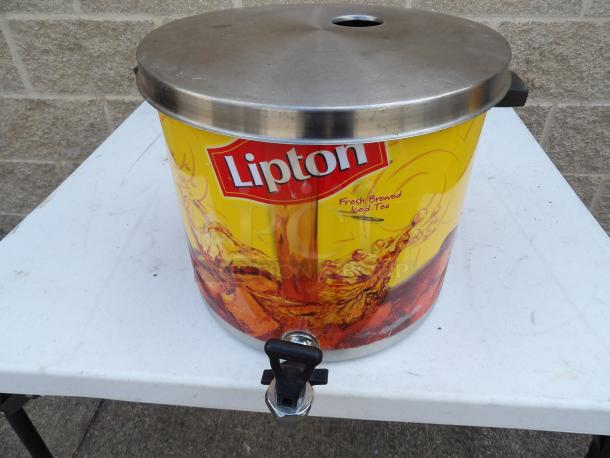 Stainless steel Lipton tea dispenser, featuring a yellow design with "Fresh Brewed Iced Tea" text. Includes a secure spigot.