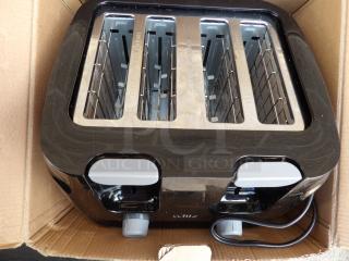 Brand new Willz 4 Slice Toaster in box, black finish, dual control dials, stainless steel slots, and visible power cord.