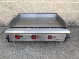 Like new MoTak MGR36-T 36" gas griddle with thermostatic controls, 3/4" steel plate, labeled with brand name.