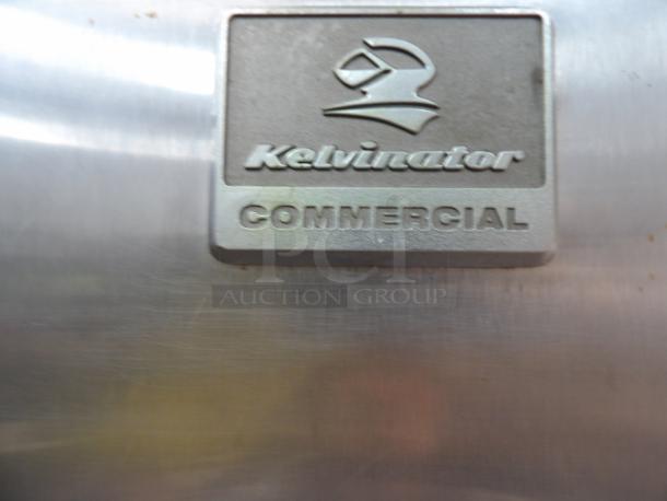 Kenmore commercial refrigerator, model KFS22 ORHY2, with "Kelvinator Commercial" label, powers on and cools.