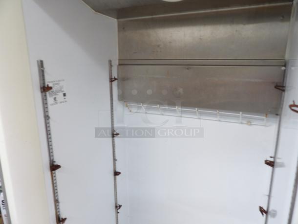 Kenmore commercial refrigerator, model KFS22 ORHY2, with adjustable shelves and stainless interior. Powers on and cools.