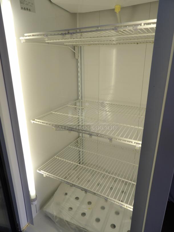 Standex BLG-27HD single glass reach-in freezer merchandiser with poly-coated racks. Powers on, not cooling. 115/220V, 1 phase.