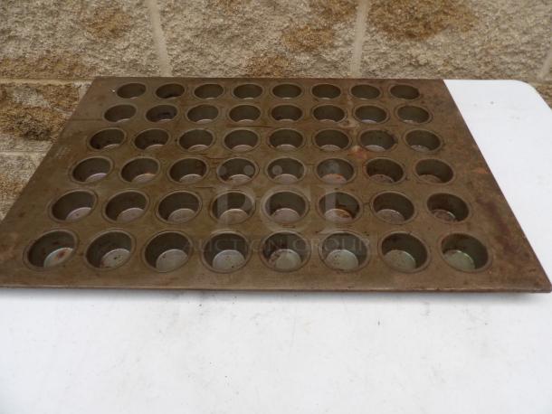 Large muffin pan for 48 muffins, dimensions 18x26 inches, each cup 1.2 inches round, slightly weathered condition.