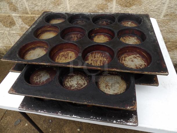 Stack of worn pot pie pans, 5-inch round, 18x26 size, showing rust and wear on baking surfaces.
