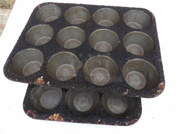 Two vintage 3.5-inch round muffin pans, 12 cups each, visible wear and patina, ideal for collectors or rustic decor.