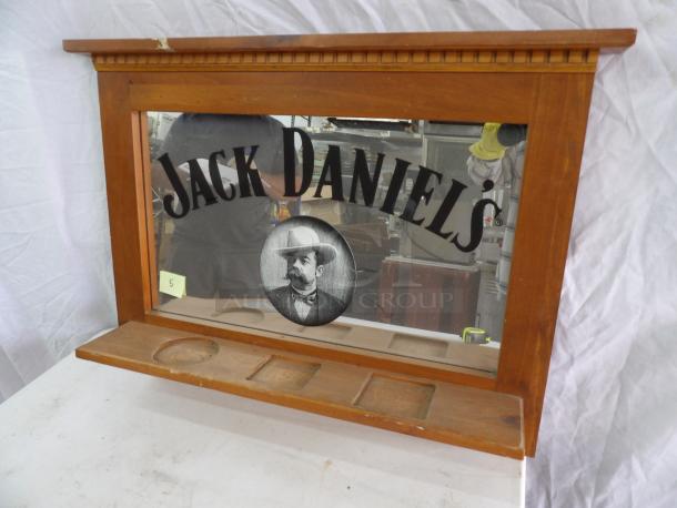 Jack Daniels mirror, 31x24 inches, featuring a wooden frame with decorative molding. Includes brand logo and vintage portrait.