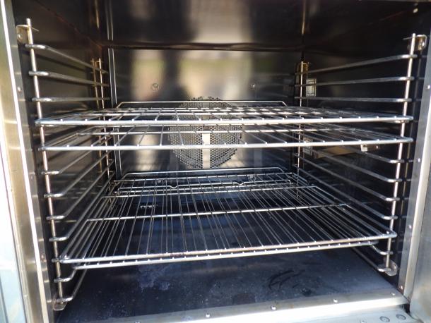 DCS stainless steel commercial electric convection oven, model FSCO-1EM240, with metal racks and view-through door.