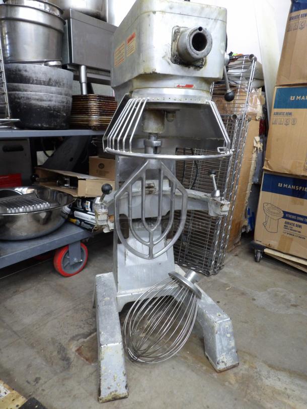 Thunderbird ARM-30N 30 Quart Metal Dough Mixer, features bowl guard, whisk, and paddle, powered on, commercial use condition.