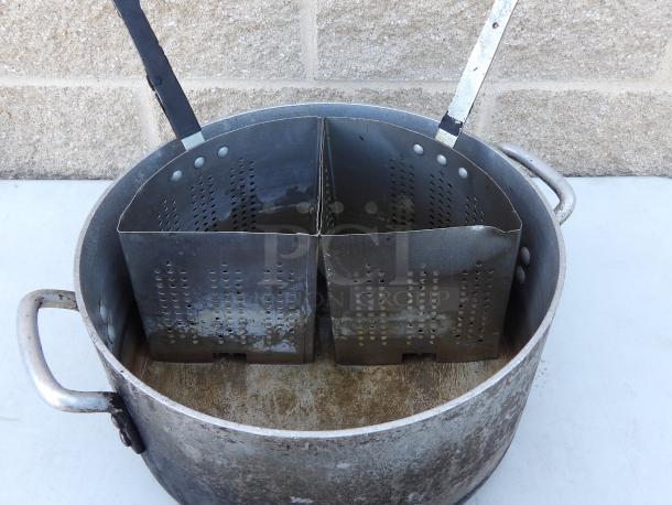 Aluminum pot with four removable metal strainers, 14" round x 7.5" deep. Used condition with wear visible.
