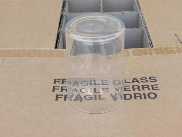 Libbey 10oz. water glass on cardboard marked "Fragile Glass" indicating delicate handling; pristine condition.
