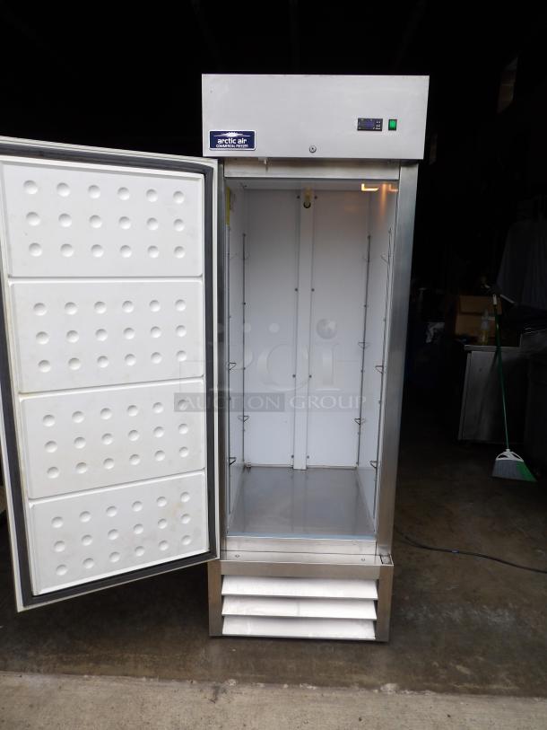 Like new Arctic Air AF-23 stainless steel single door reach-in freezer with poly-coated racks and commercial casters.