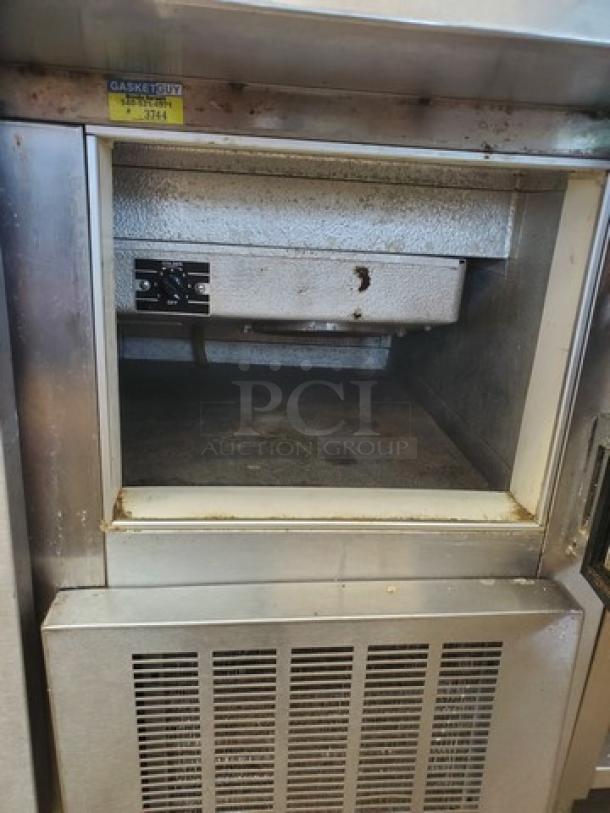 Nor-Lake ZF122SAS/0-2DQ 54" ice cream topping cabinet, stainless steel, visible signs of use, unit label identifiable.