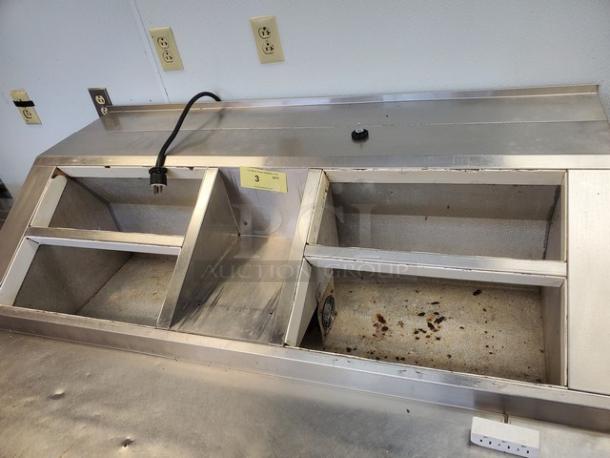 Nor-Lake ZF122SAS/0-2DQ 54" ice cream topping cabinet, stainless steel, dual compartments, used condition, visible wear.