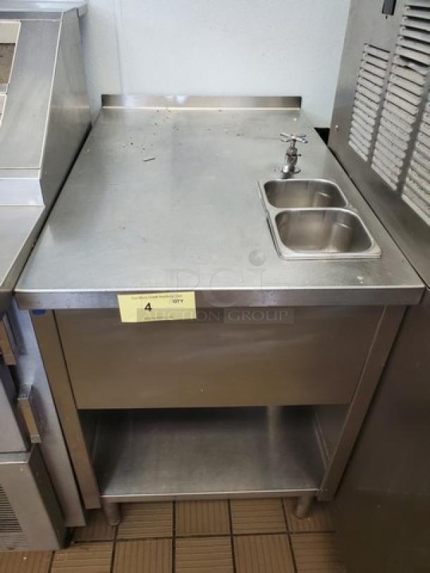 Stainless steel work station with sink, upper counter, and lower shelf. Good condition. Marked with quantity tag "4".