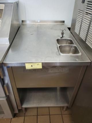 Stainless steel work station with sink, upper counter, and lower shelf. Good condition. Marked with quantity tag "4".