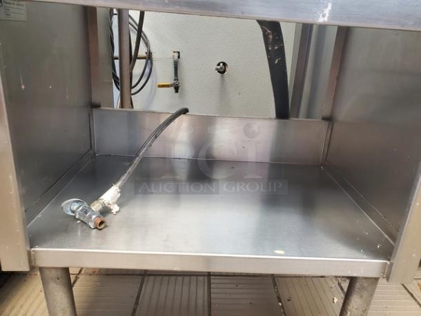 Stainless steel workstation with sink, Seelye Craftsmen, model 132-003 L, featuring sturdy construction and plumbing fixtures.