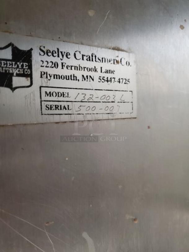 Stainless steel workstation with sink by Seelye Craftsmen, model 132-003 L. Serial 500-007. Visible wear.