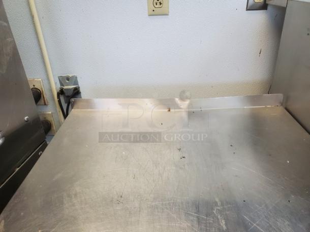 Seelye Craftsmen Model 132-003 L stainless steel workstation with sink. Shows signs of wear, suitable for industrial use.