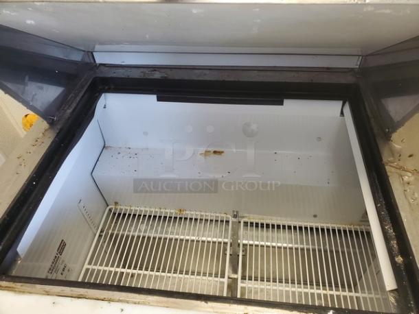 True TSSU-36-12M-B Mega-Top Solid Door Sandwich/Salad Unit, interior view, shelving visible, good used condition.