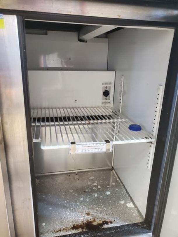 True Mega-Top Solid Door Sandwich/Salad Unit, model TSSU-36-12M-B. Features: stainless steel construction, adjustable shelving. Some wear visible.
