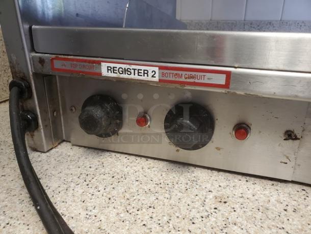 International Dairy Queen DD29 double level food warmer, featuring control knobs and circuit labels, visible wear on metal surface.