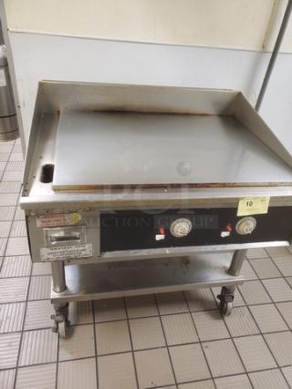 Miraclean natural gas griddle, stainless steel, dual control knobs, mounted on a wheeled stand, used condition.