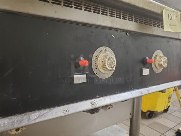 Miraclean natural gas griddle control panel with knobs and switches. Used condition. Vent and utility area visible.