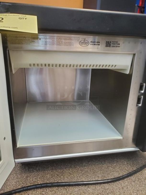 Amana Menumaster commercial microwave oven, model DQ22HSI3. Stainless steel interior, excellent condition, visible control panel.