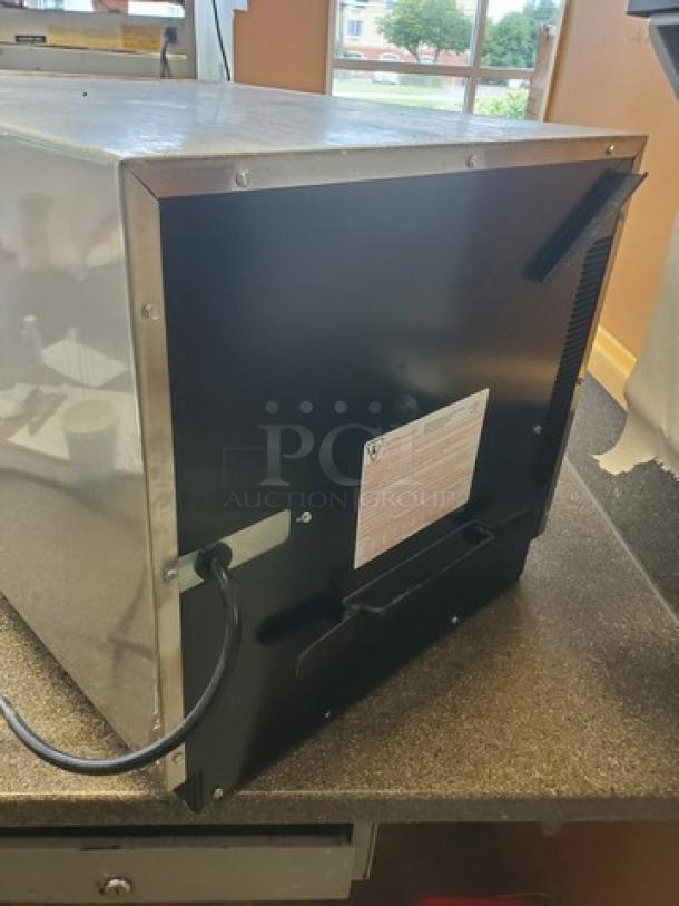 Amana Menumaster Commercial Microwave Oven, Model DQ22HSI3, stainless steel exterior, visible power cord and label on the back.