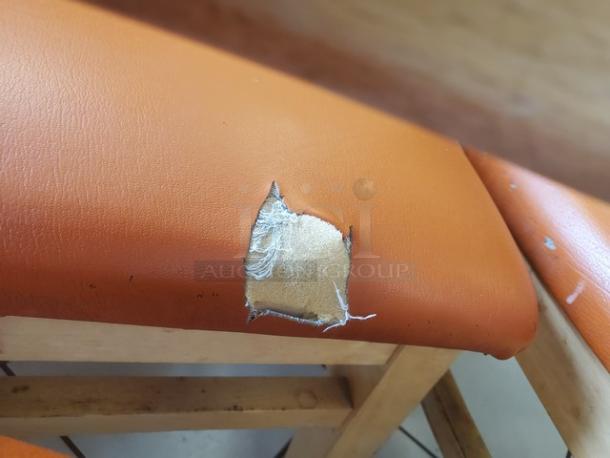 Lot of 5 chairs, orange cushions, one has a hole; wooden frames, condition varies.