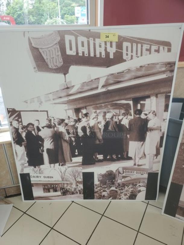 Vintage Dairy Queen wall decor, featuring sepia-toned images of a crowd and signage. Item in good condition.